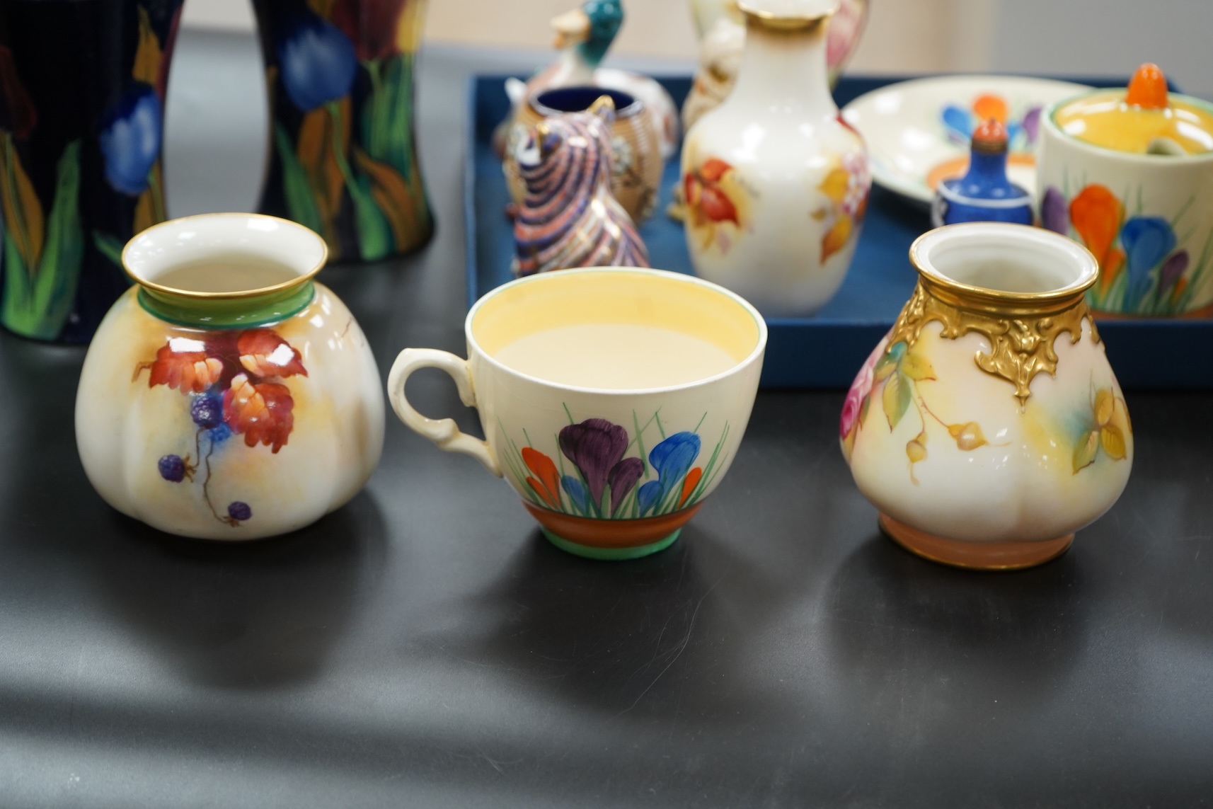 A collection of mixed porcelain and pottery to include four Worcester vases, one signed H. Blake, Clarice Cliff crocus pattern cup, saucer and sugar bowl and two Doulton Imari paperweights, largest 13cm high